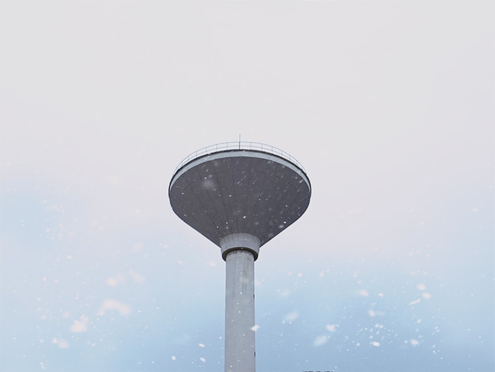 white and black tower under white clouds