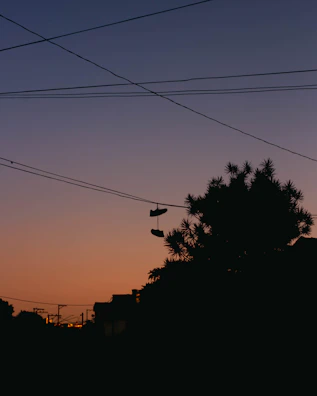 Sneaker silhouette against a sunset skyline, capturing city vibes.