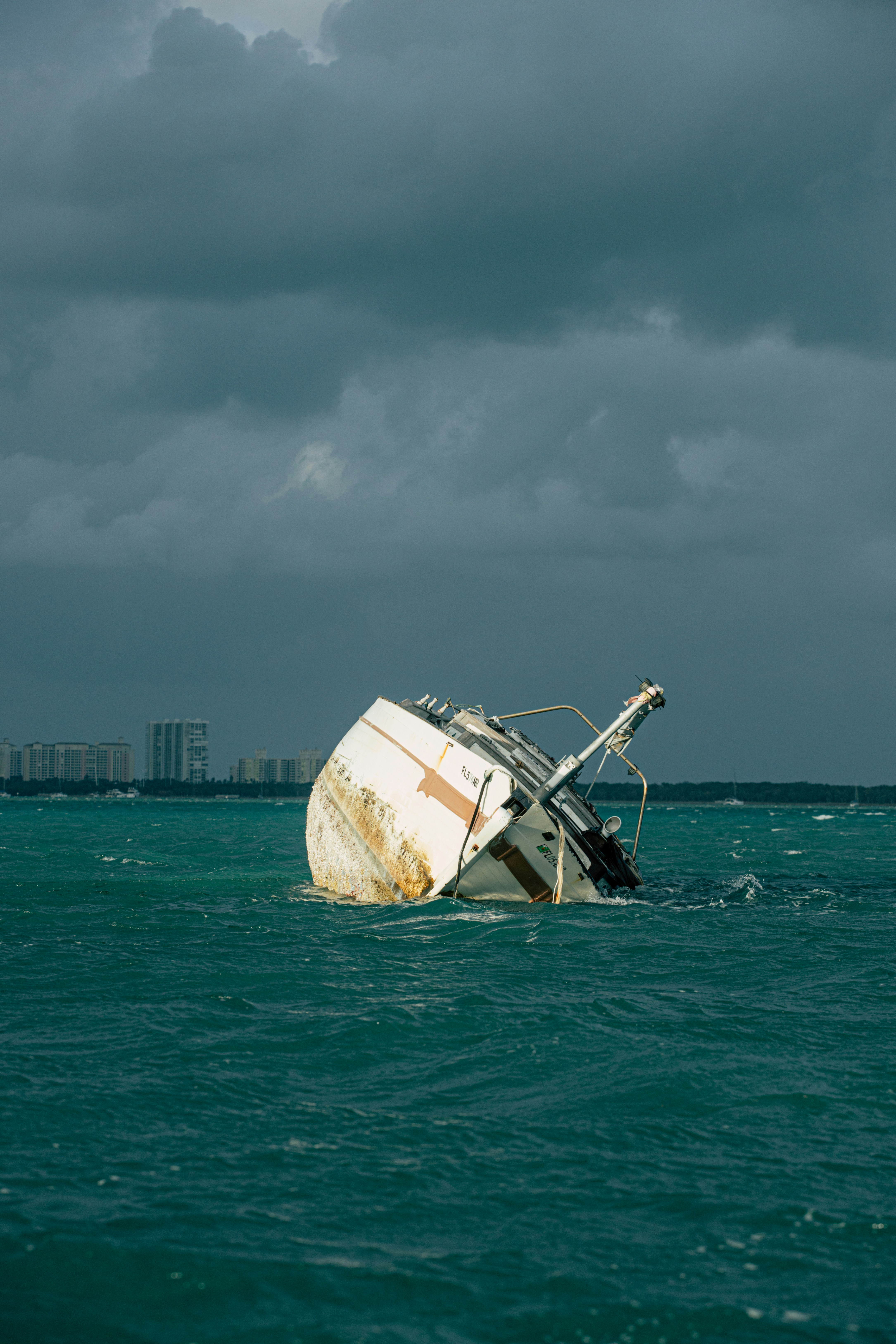 white and brown ship on sea under gray sky