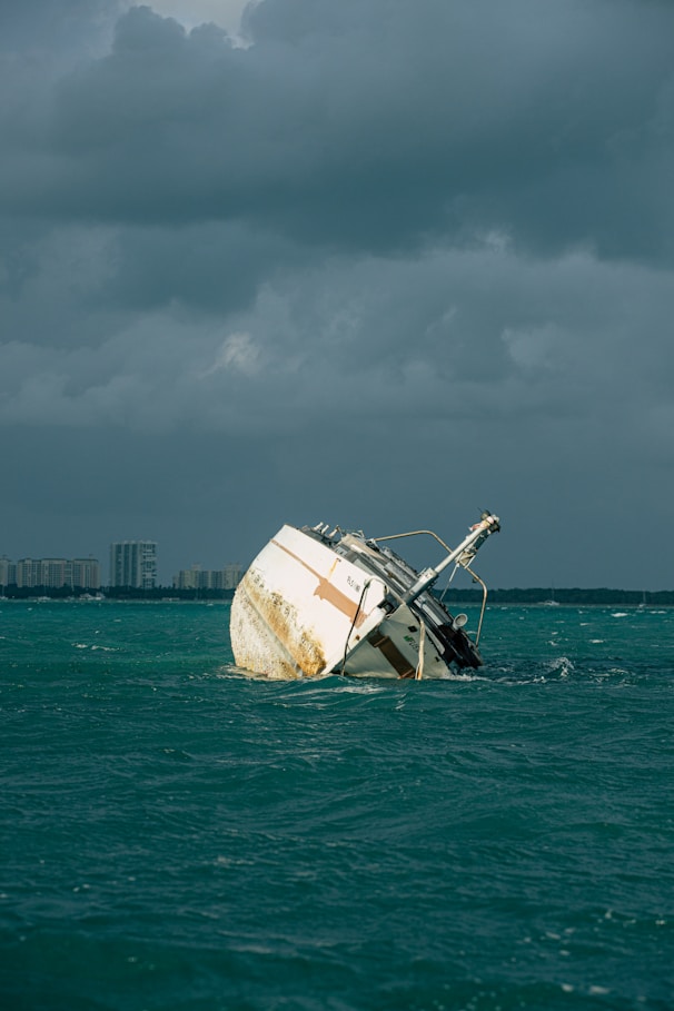 white and brown ship on sea under gray sky