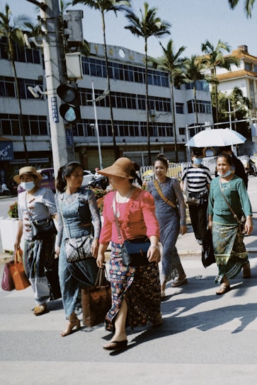 A diverse group of stylish people walking outdoors.