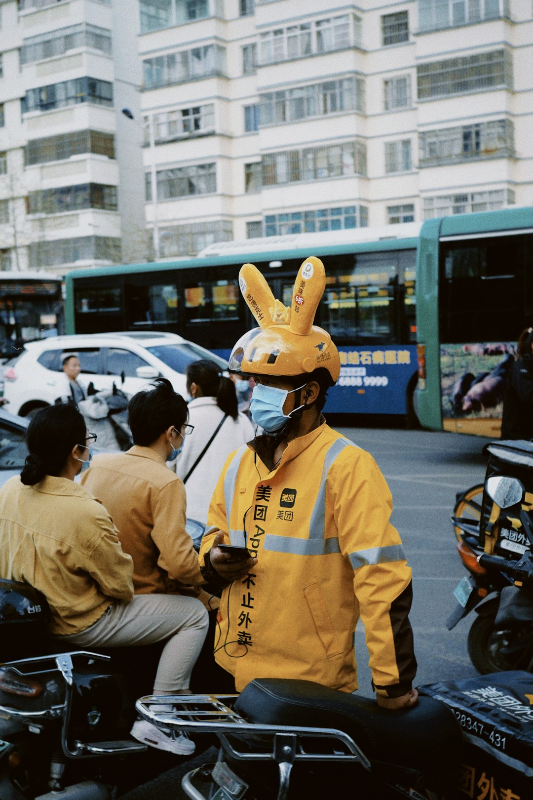 people in yellow and white uniform riding motorcycle during daytime