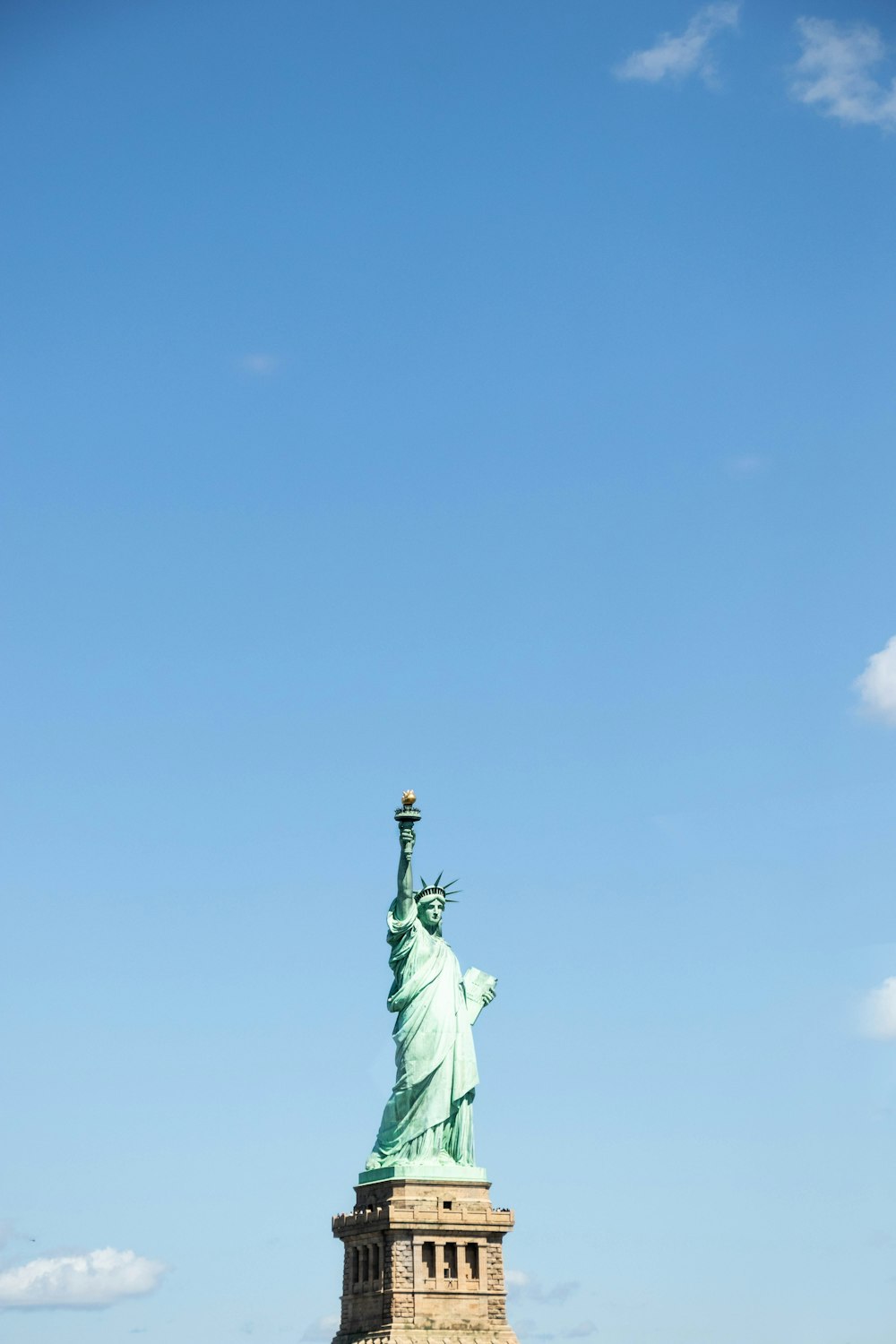 statue of liberty under blue sky during daytime