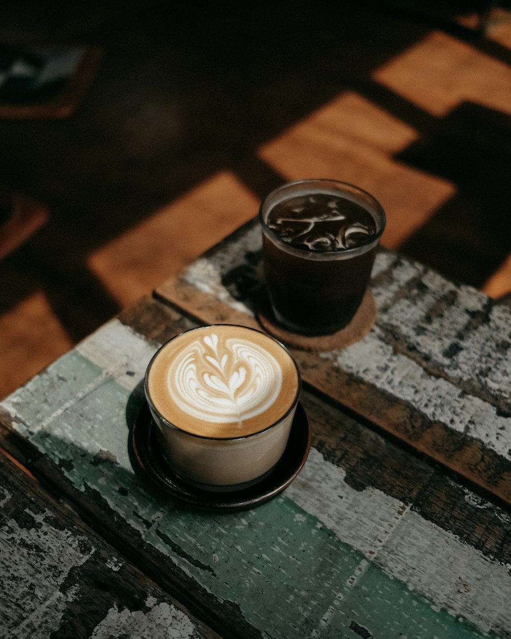 black and white coffee cup on black wooden table