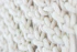 white knit textile on brown wooden table