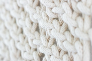 white knit textile on brown wooden table