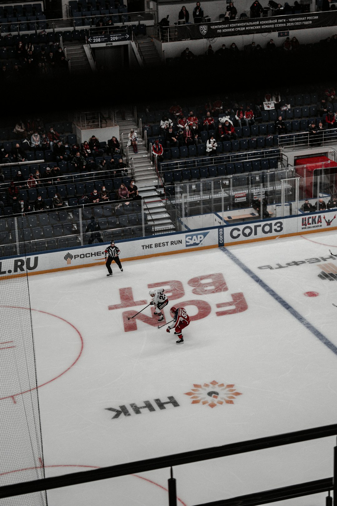 man in white and red jersey shirt playing ice hockey