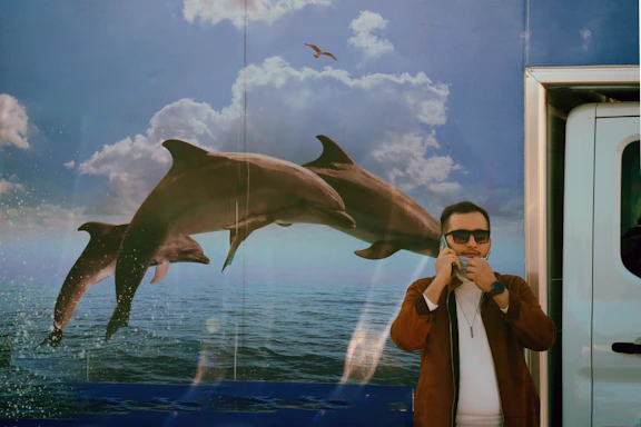 A friendly technician answering a phone call inside a water damage restoration van in Key Biscayne.