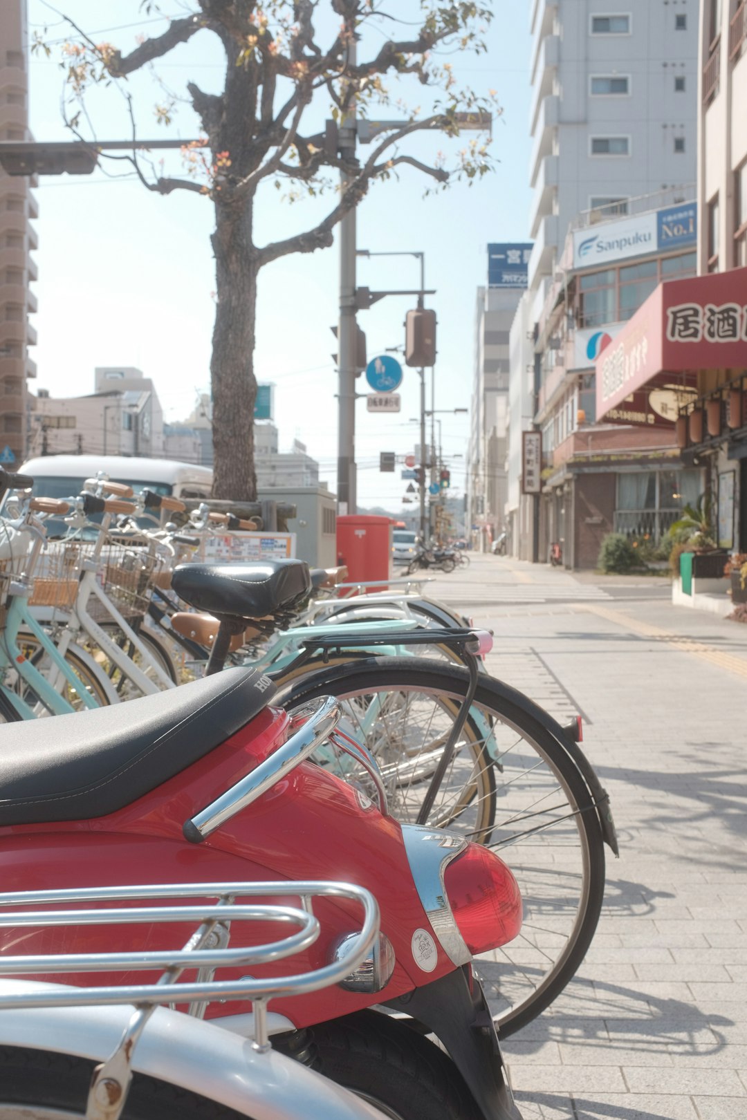 red and black motorcycle parked on sidewalk during daytime