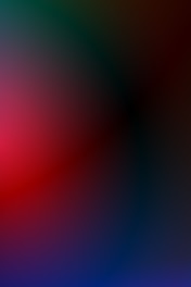 A gradient of colors blends smoothly across the image, featuring dark greens, reds, and blues. The overall effect creates a soft, abstract appearance with no distinct shapes or objects.