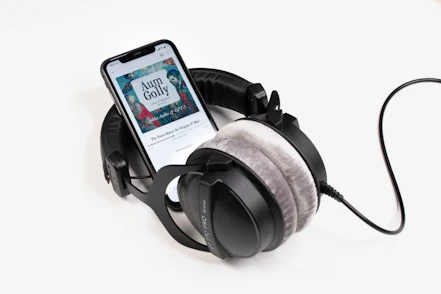 Person wearing headphones, deeply engaged in a healing audiobook session