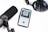 A smartphone displays an audiobook app with the cover art for 'Aum Golly' by Hokusai on its screen. Nearby, a large black microphone and a set of black studio headphones are placed on a white surface, suggesting an audio recording or podcast setup.