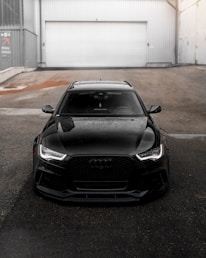 black bmw m 3 parked on parking lot during daytime