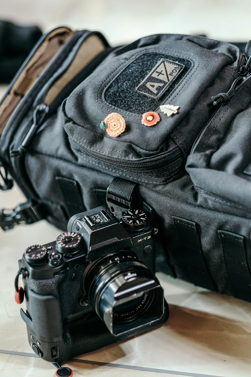 black nikon dslr camera on black backpack