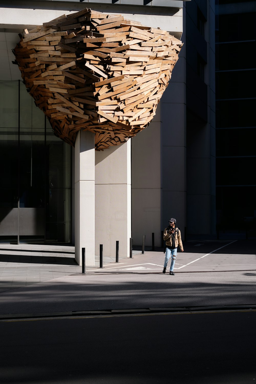 woman in black jacket and black pants walking on sidewalk during daytime