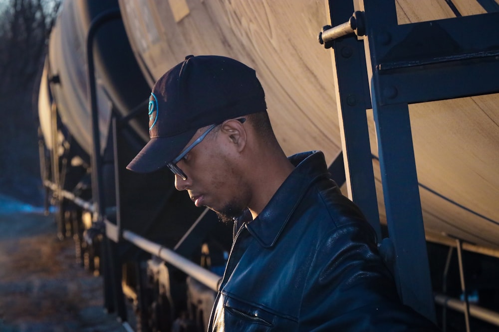 man in black jacket and black cap