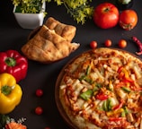 pizza with cheese and tomatoes on brown wooden round plate