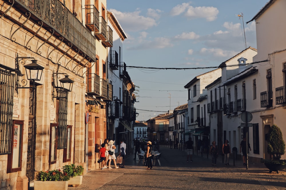 people walking on street between buildings during daytime