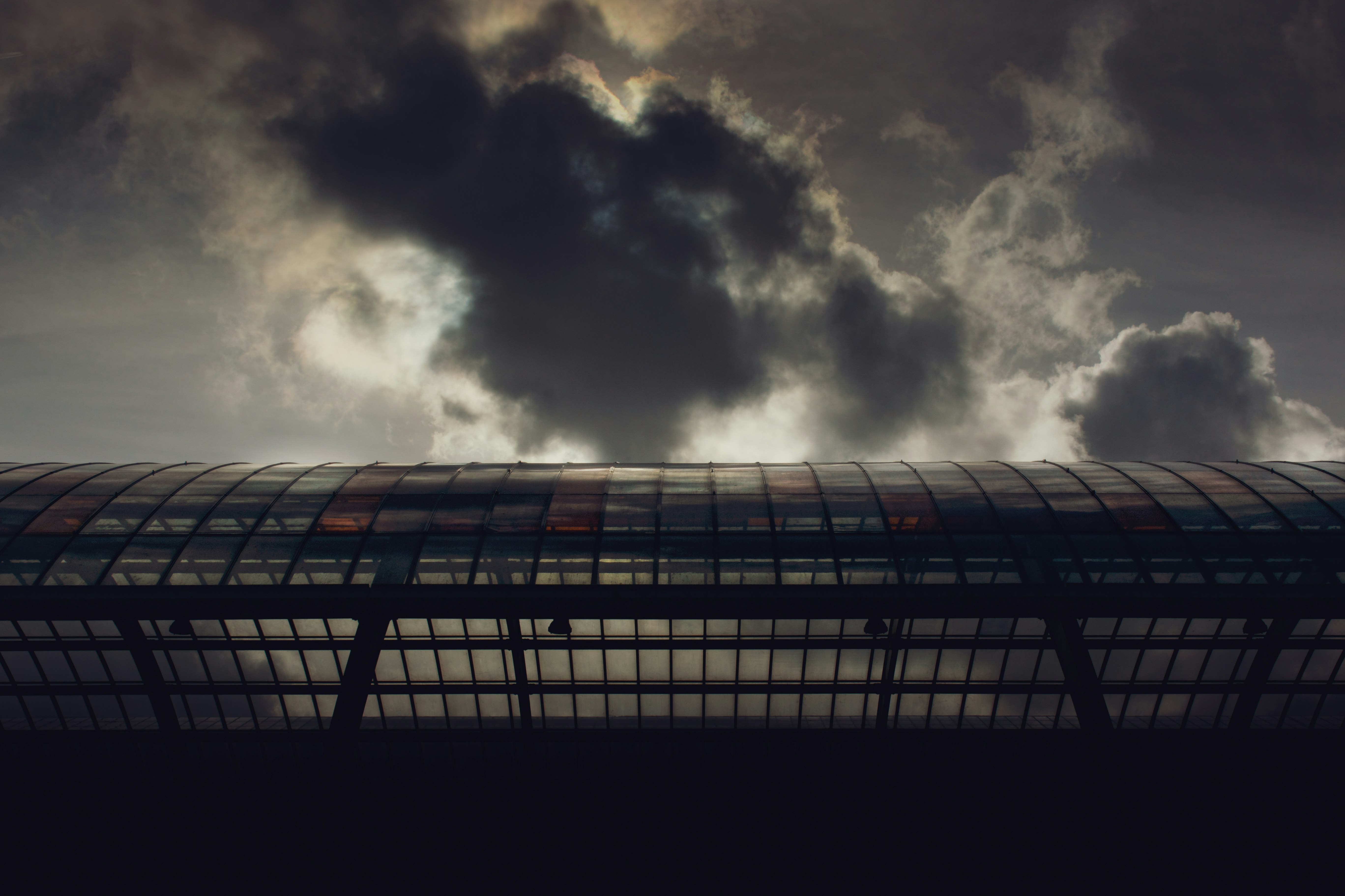 low angle photography of high rise building under cloudy sky