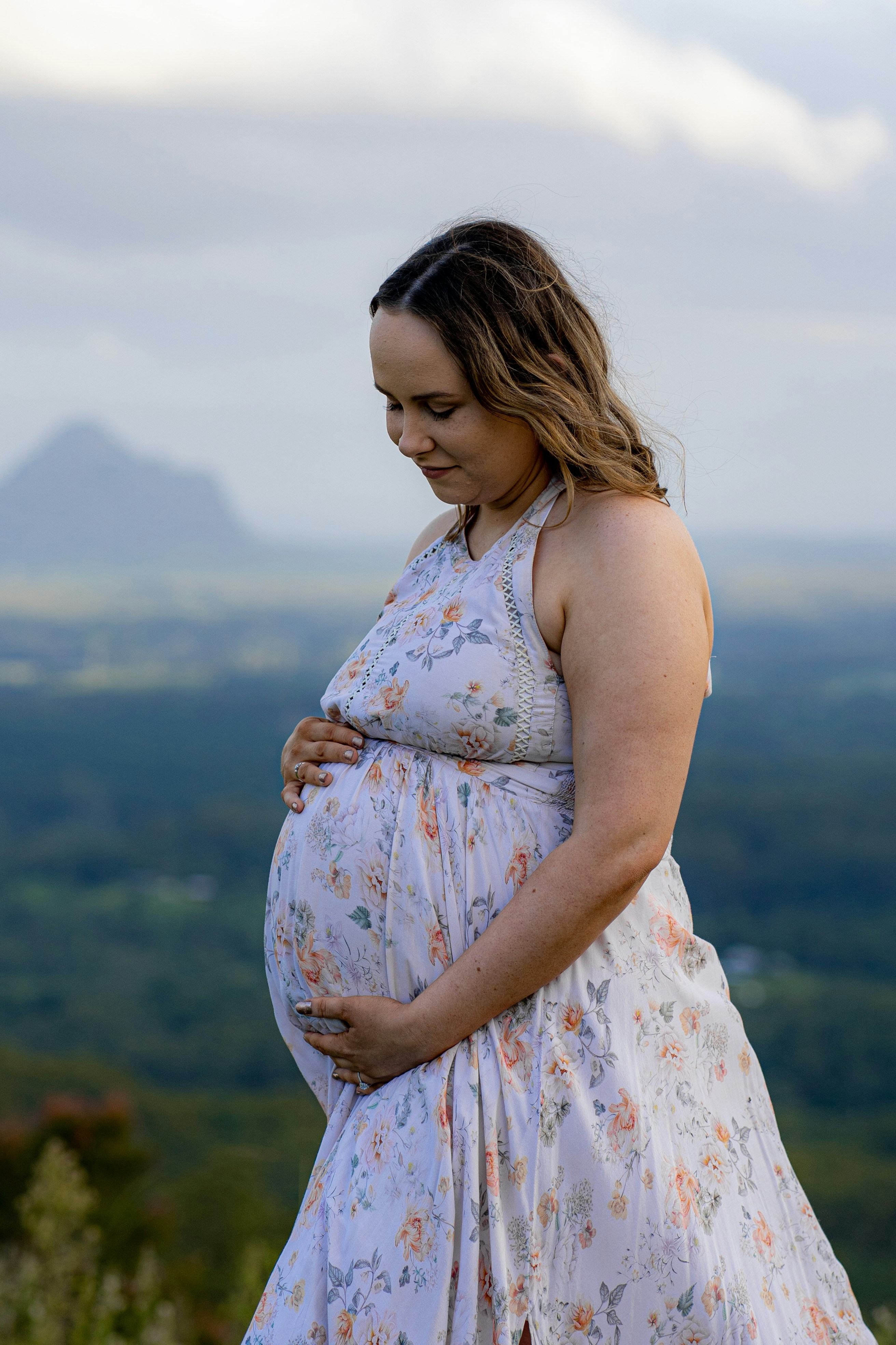 woman in white and pink floral spaghetti strap dress