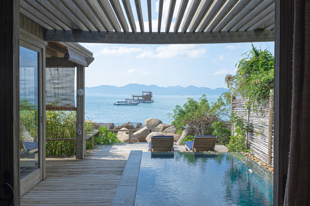 brown wooden chairs near swimming pool during daytime