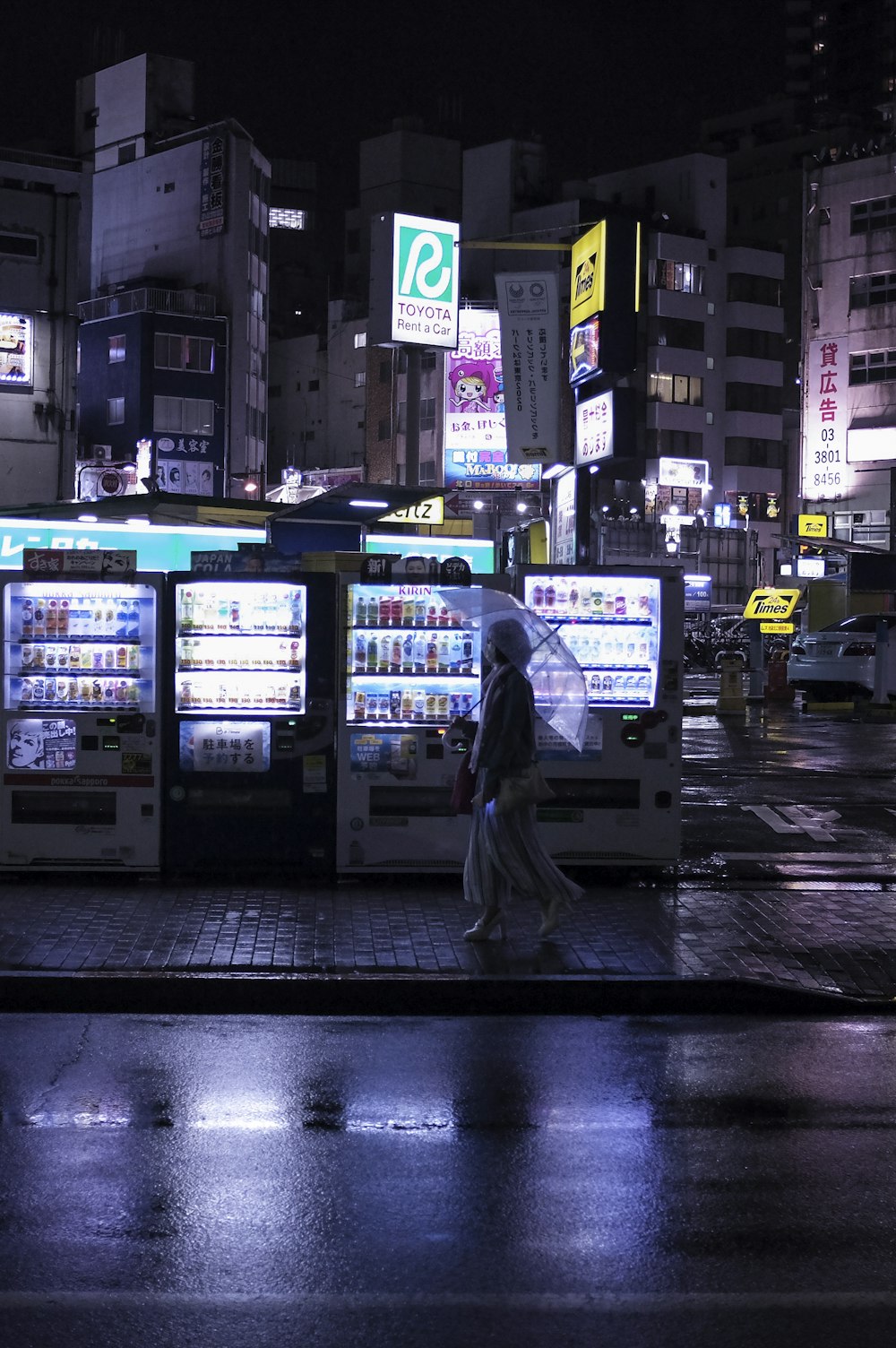 man in black jacket walking on sidewalk during night time