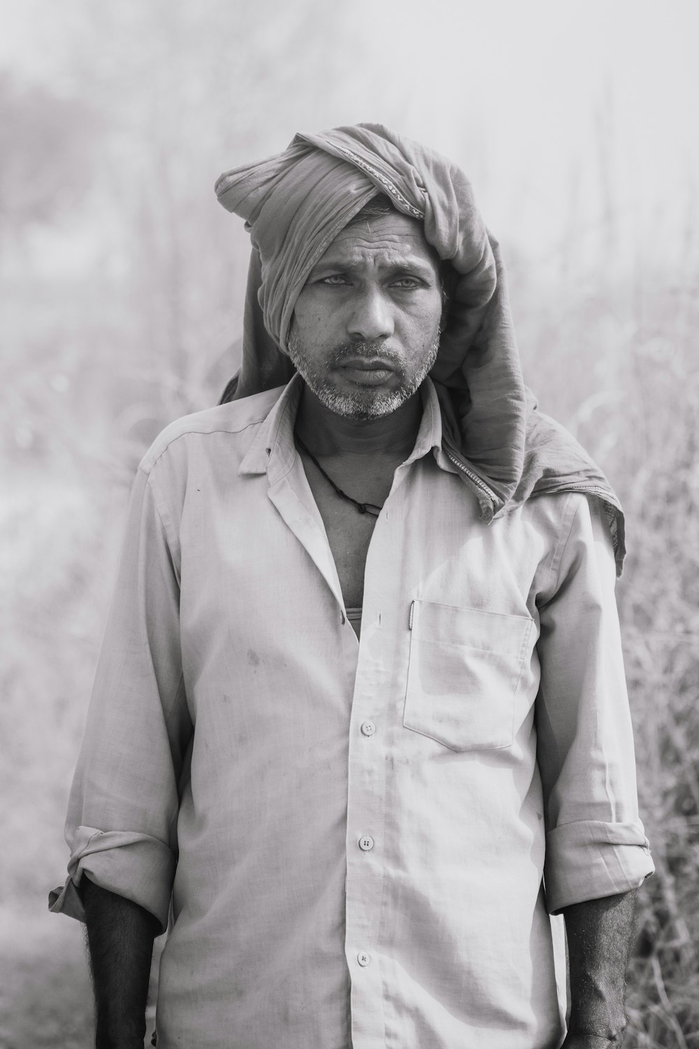 grayscale photo of man in white button up shirt