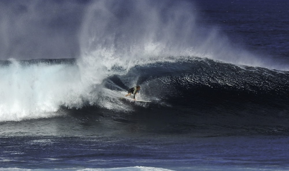 man surfing on sea waves during daytime