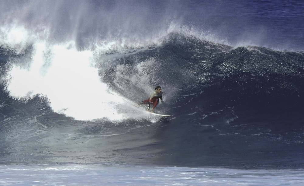 man surfing on sea waves during daytime