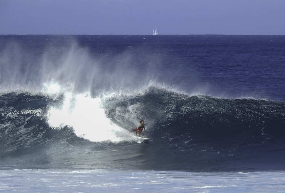 person surfing on sea waves during daytime