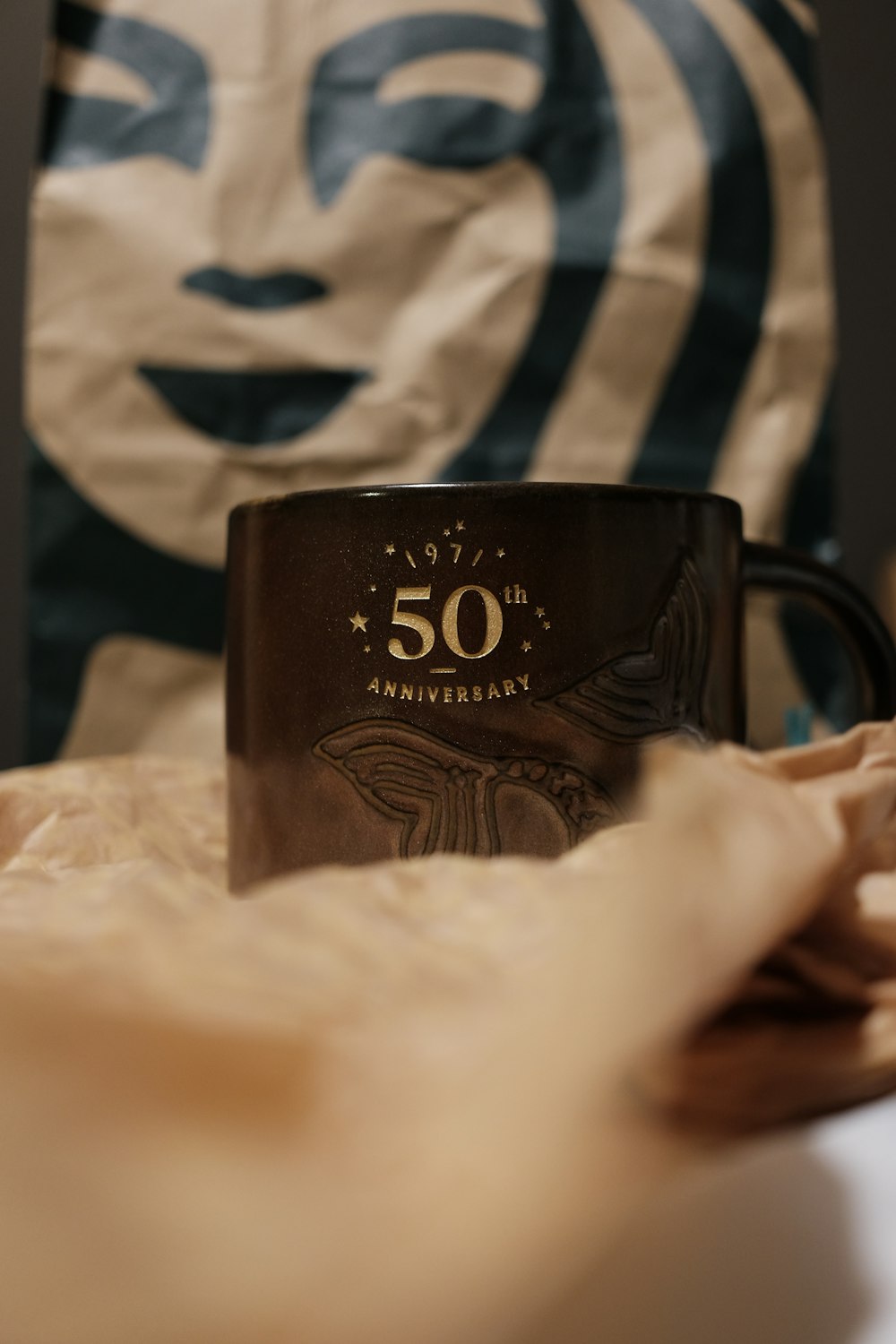 brown ceramic mug on white textile