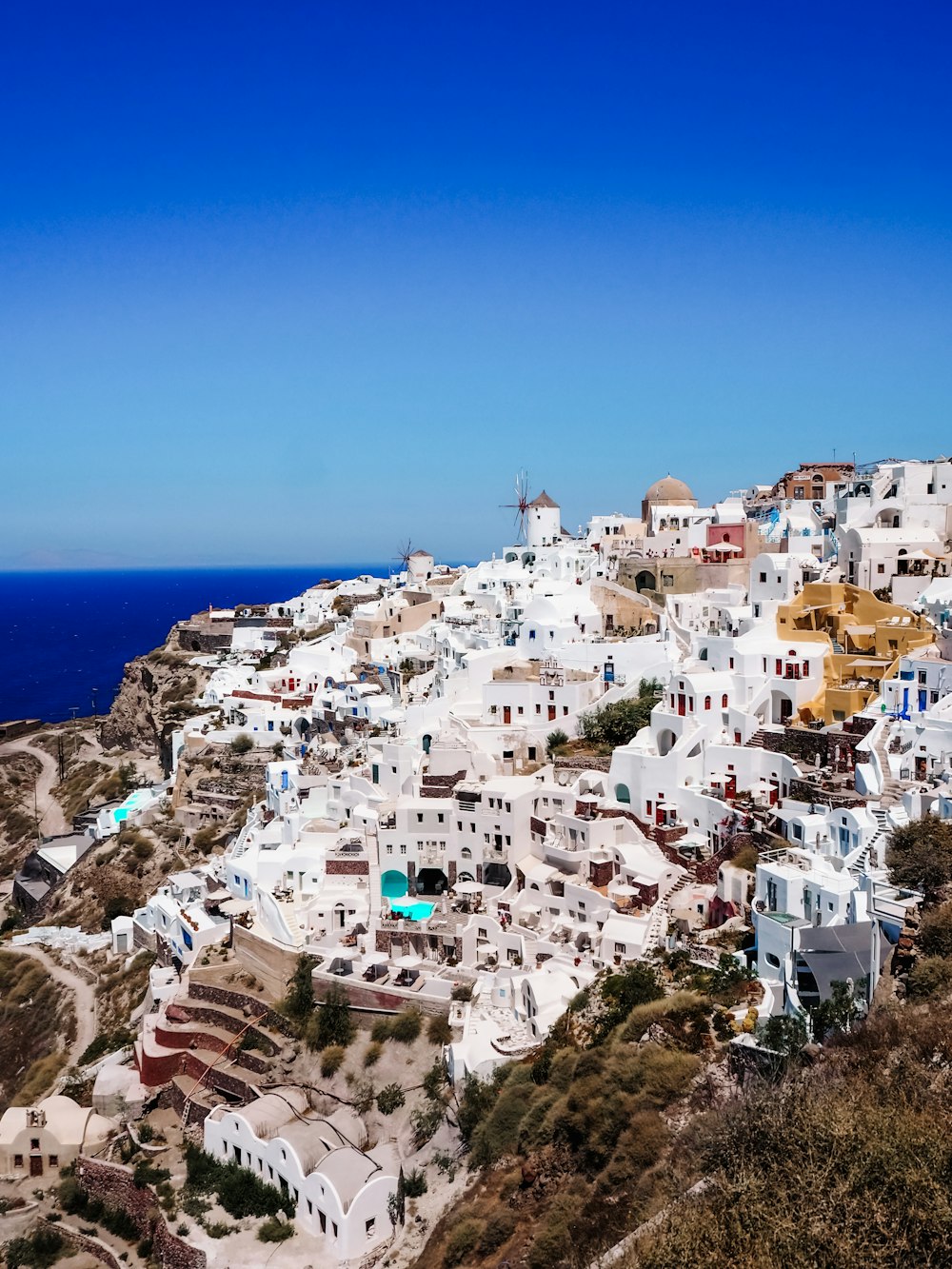 white concrete houses near sea during daytime