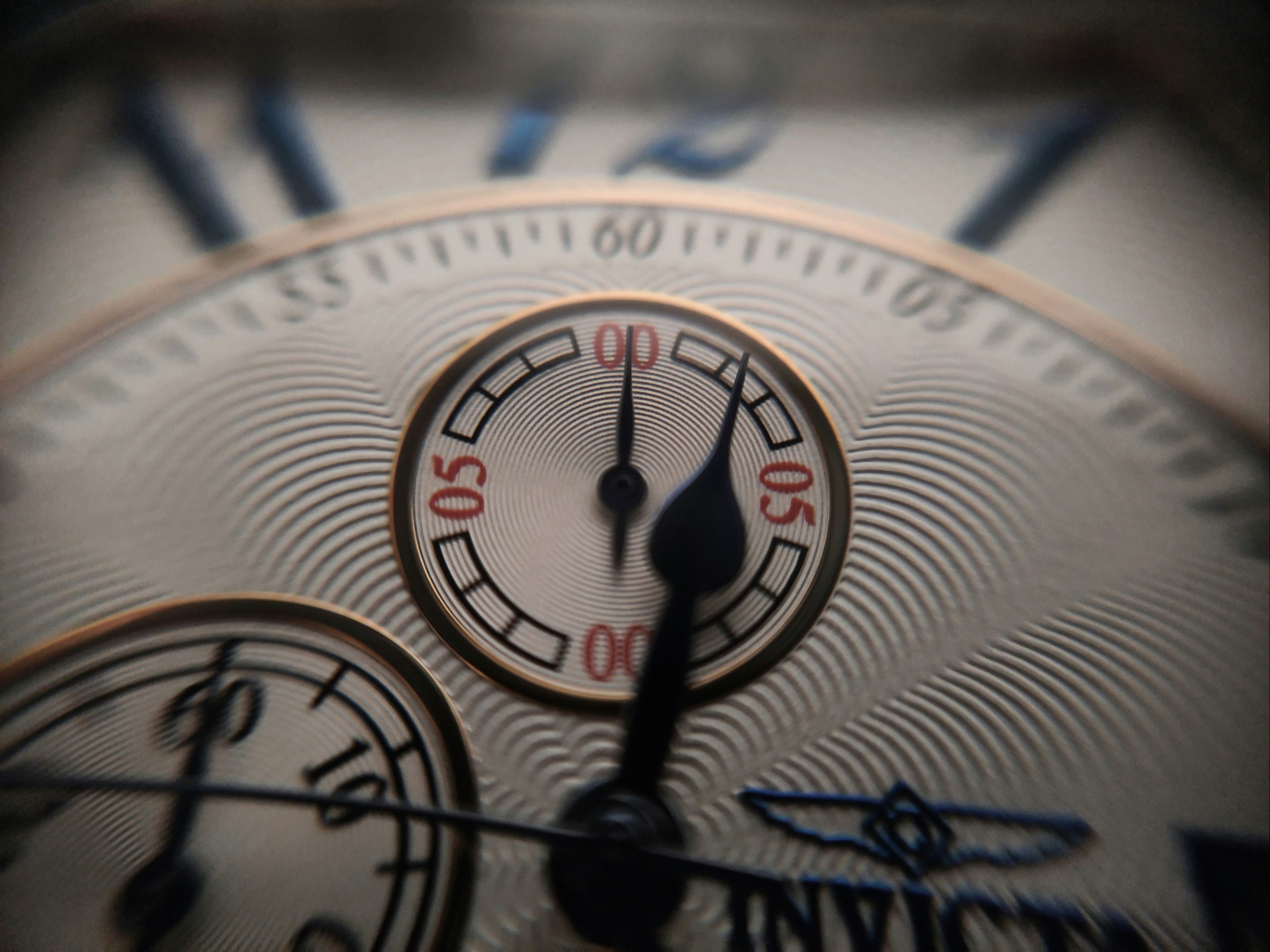 Precision watch dial with gold hands, deep black lacquer face, atmospheric macro photography