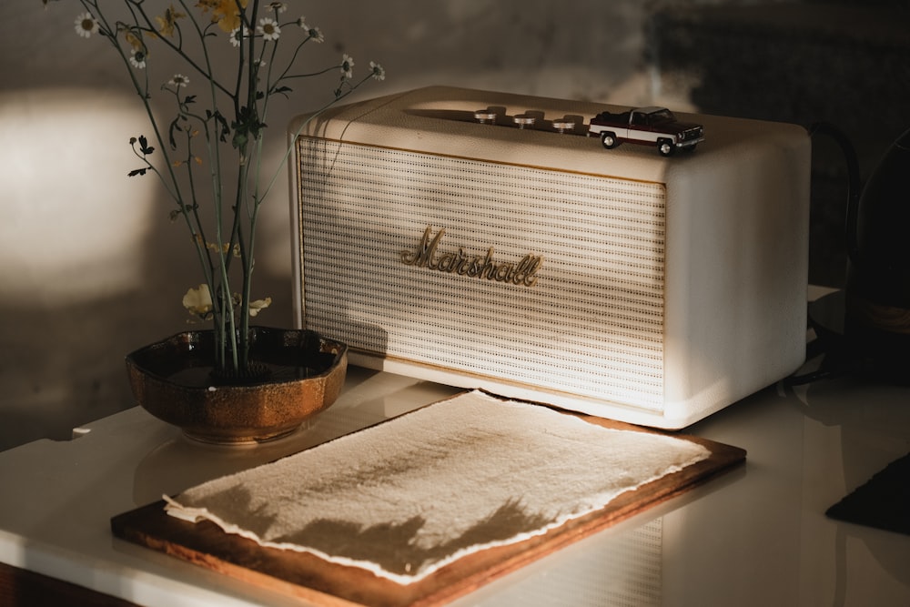 white and silver radio on white textile