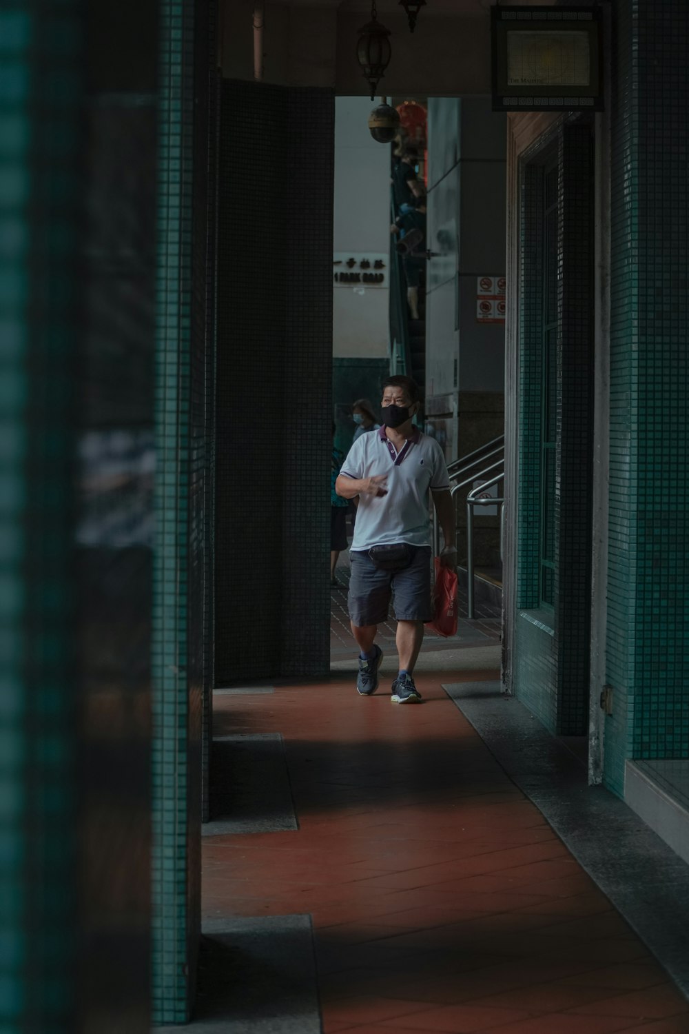 man in white dress shirt and blue denim jeans walking on sidewalk during daytime