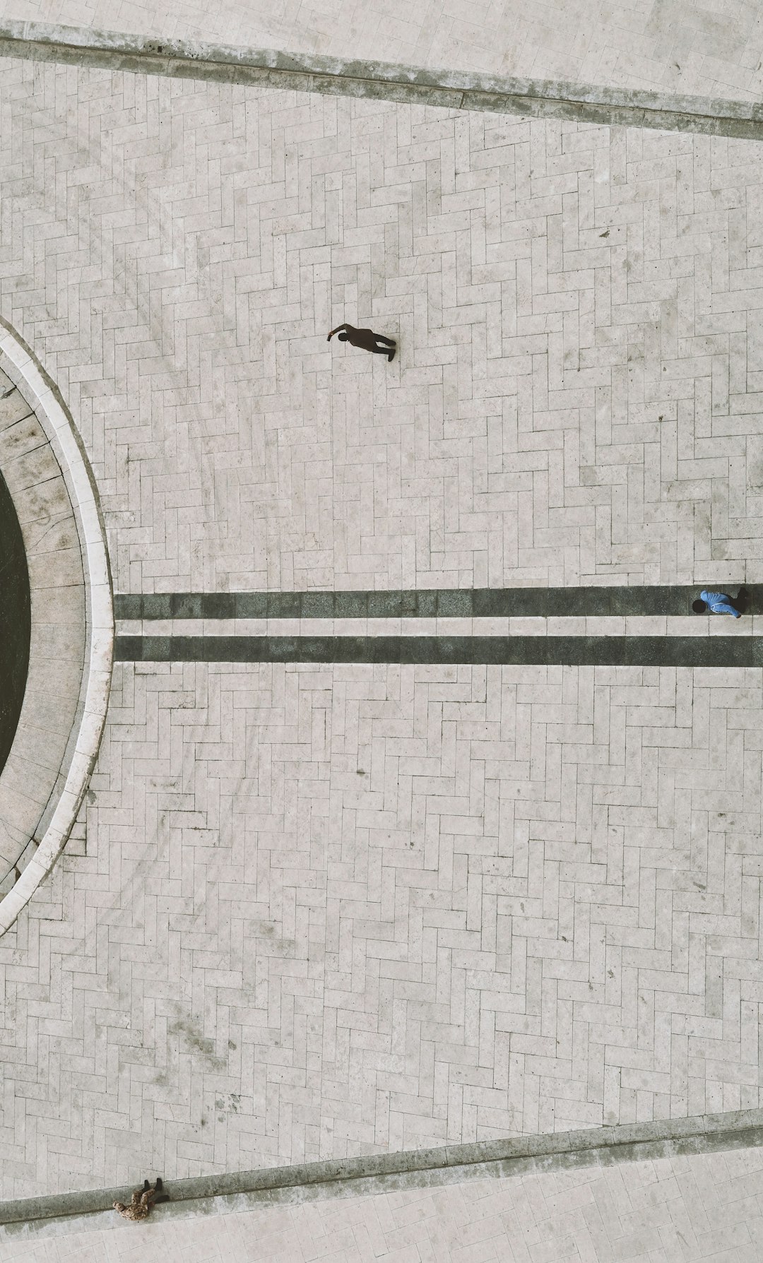 aerial view of people walking on gray concrete pavement