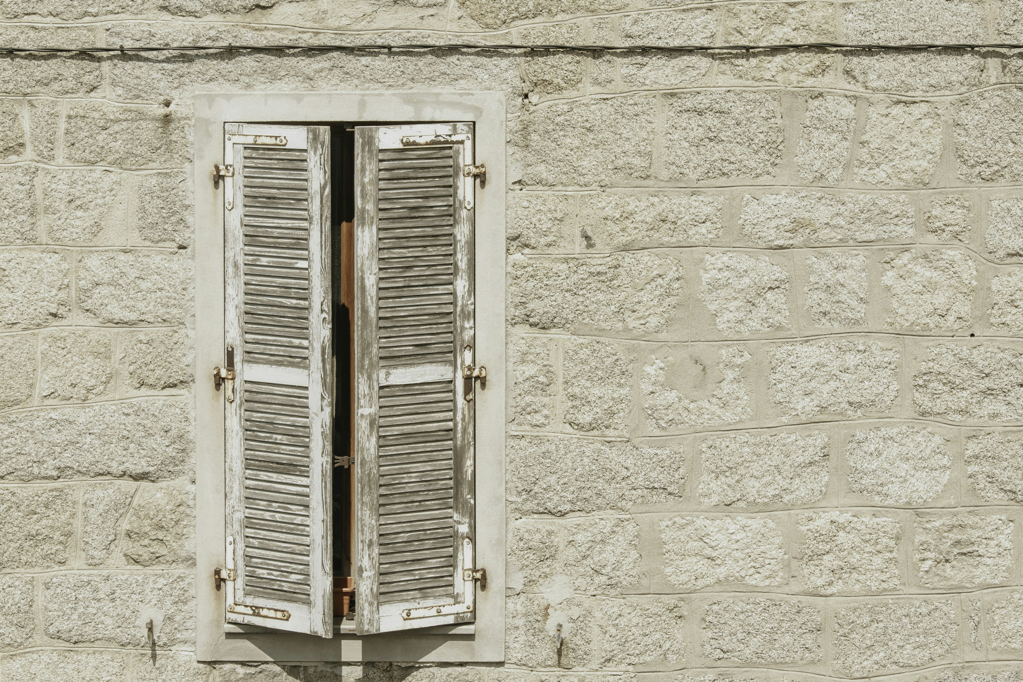 white wooden window on white concrete wall