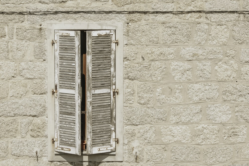 white wooden window on white concrete wall