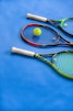 yellow and black tennis racket on blue textile