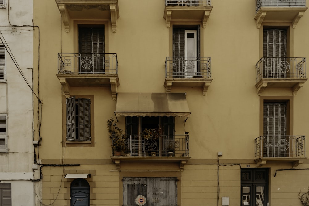 beige concrete building with brown wooden window