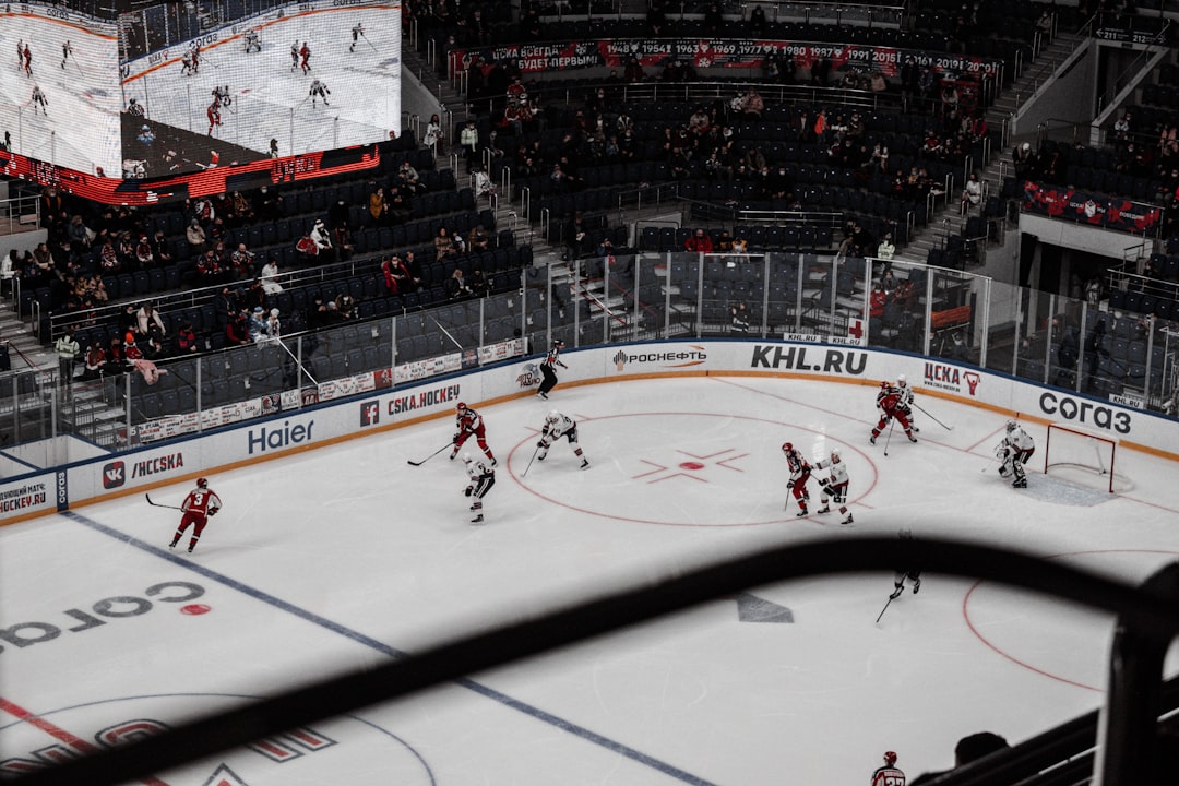 people playing ice hockey during daytime