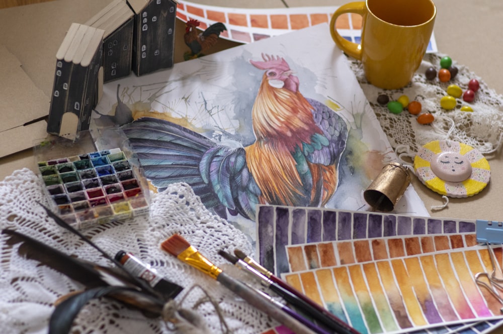 yellow ceramic mug beside blue and white painting