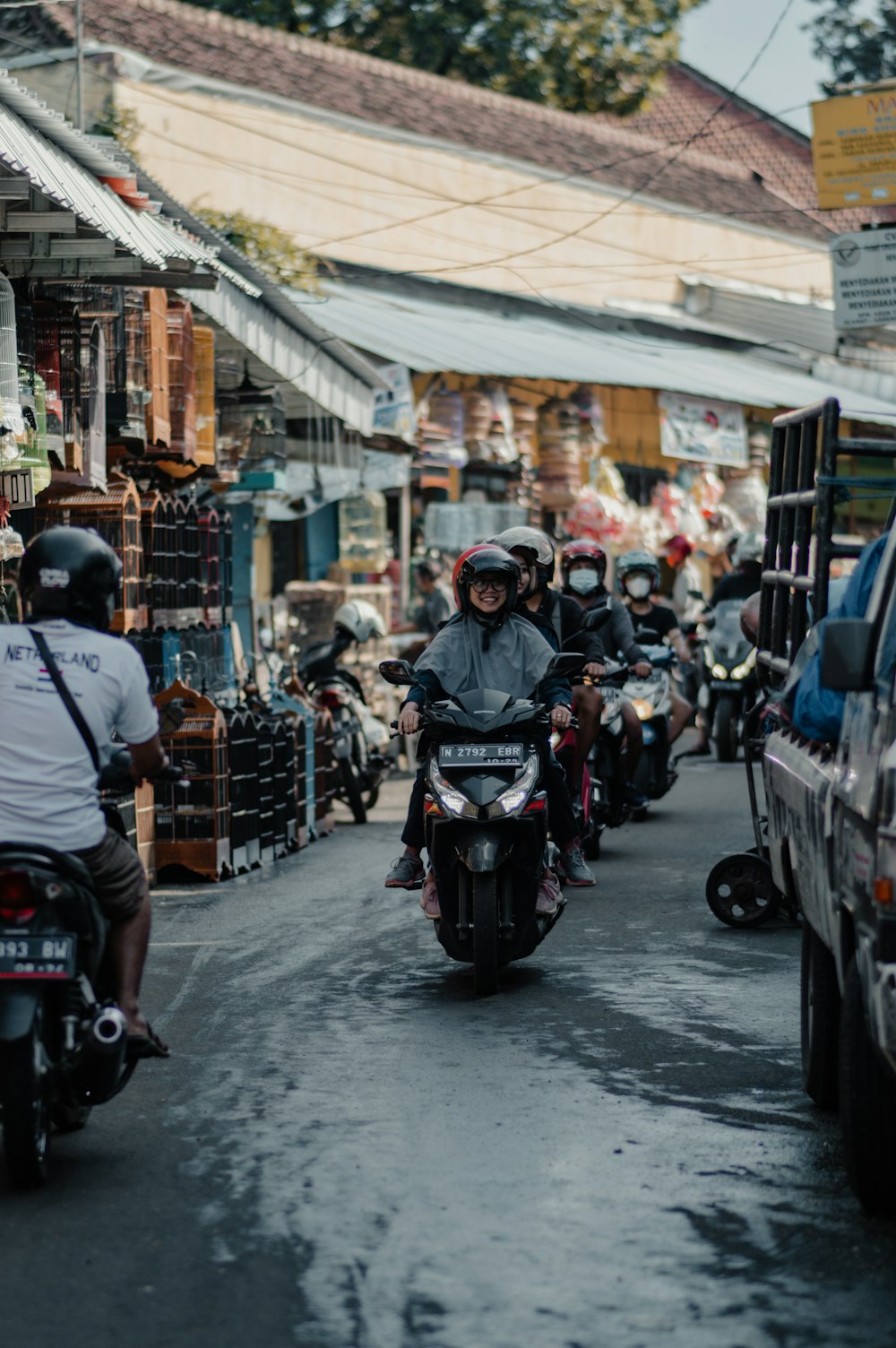 people riding motorcycle on street during daytime