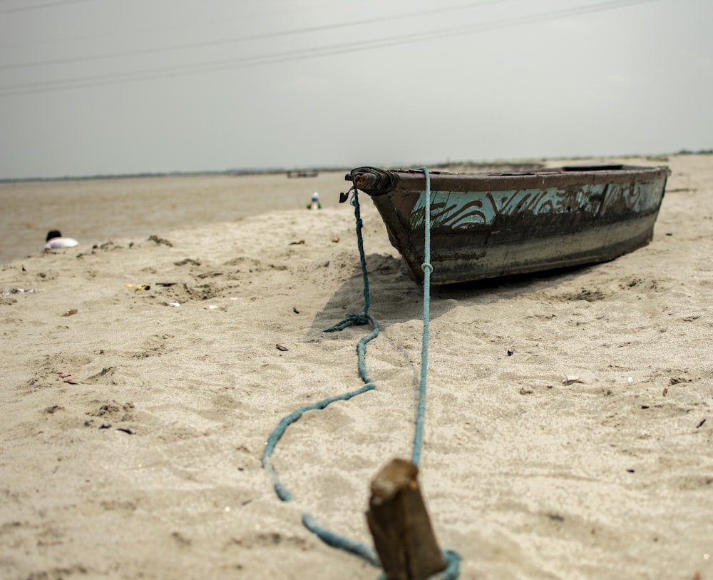 brown and green boat on beach during daytime