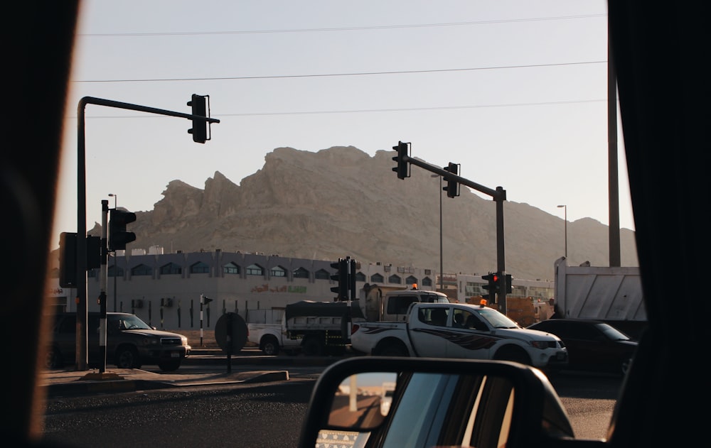 cars on road near mountain during daytime