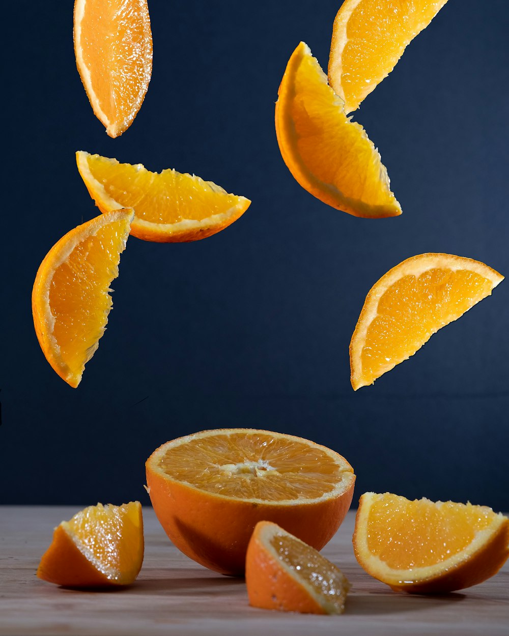 sliced orange fruit on black surface