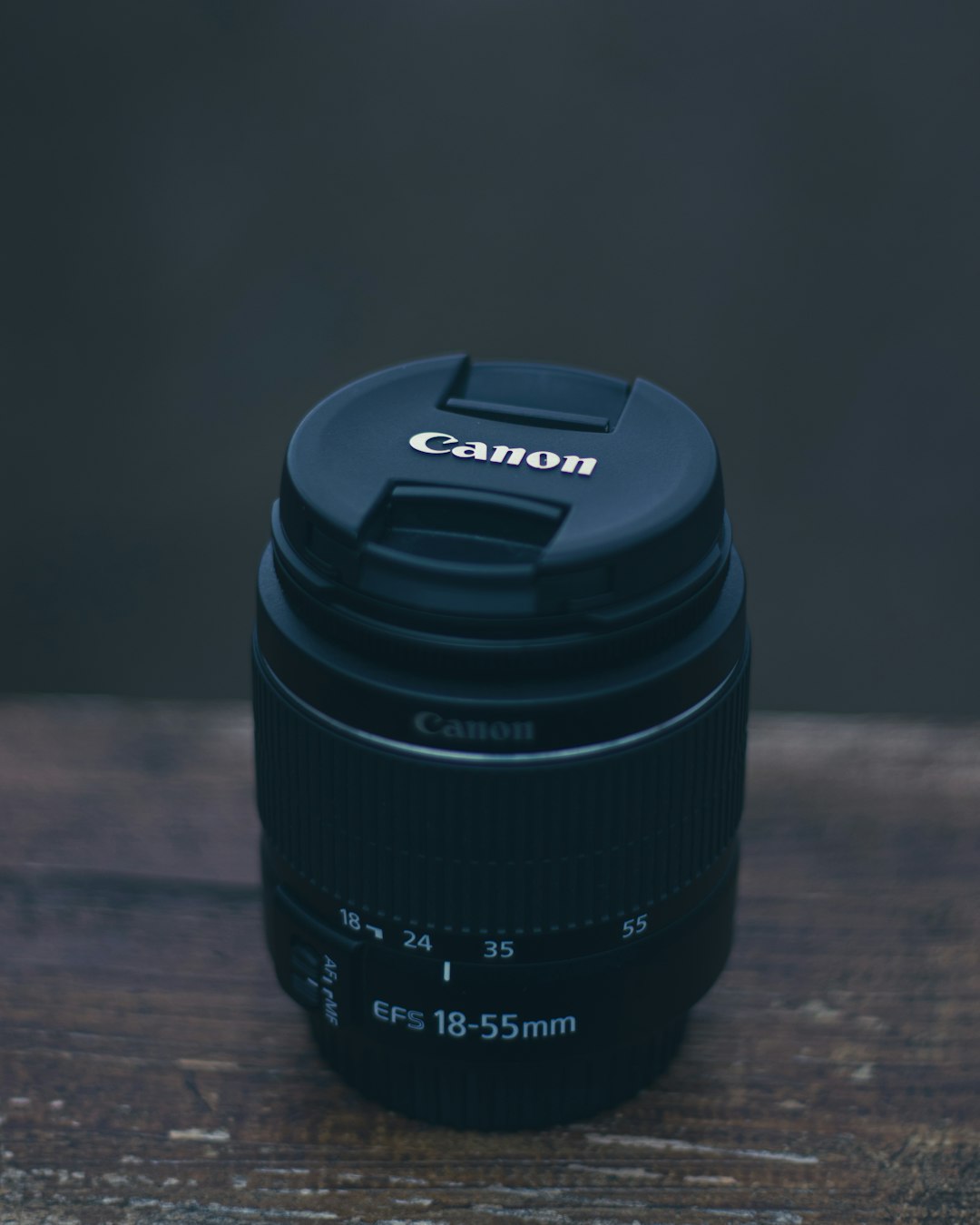 black camera lens on brown wooden table