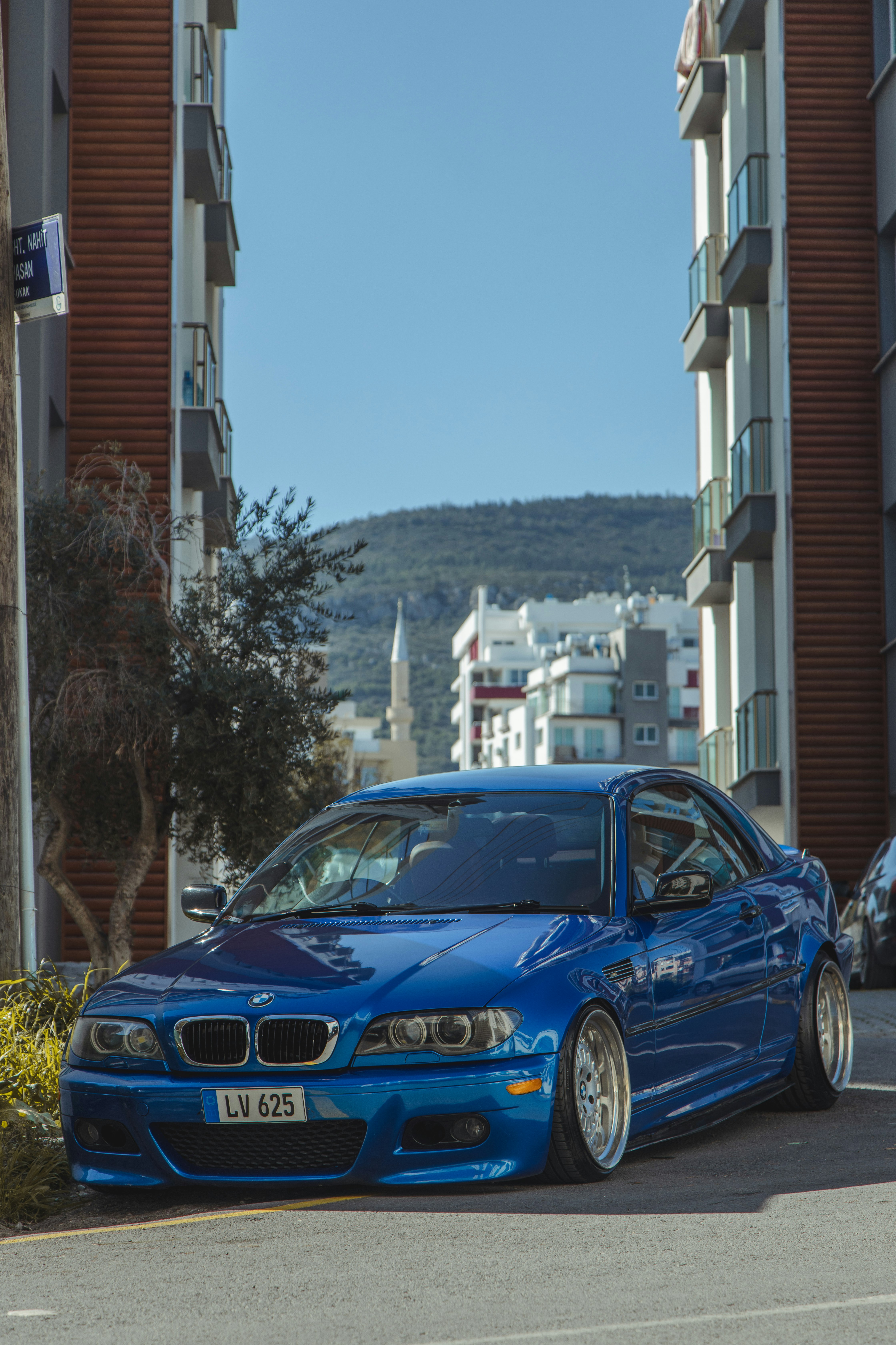 blue bmw m 3 coupe parked on street during daytime