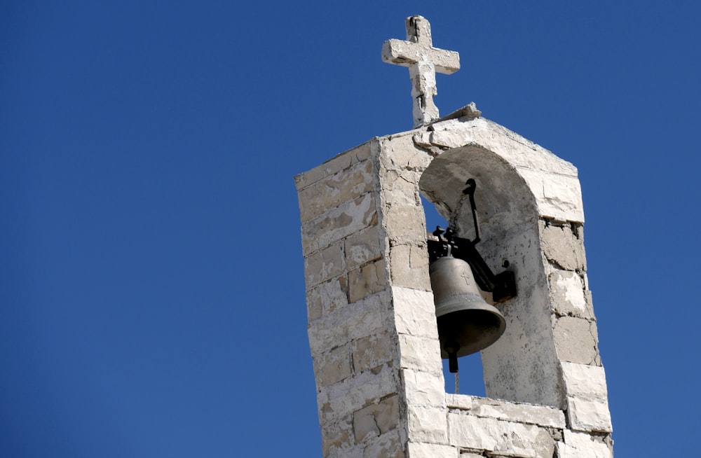 gray bell on gray concrete wall