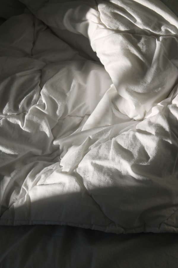 Natural white linen textile folded on a wooden surface